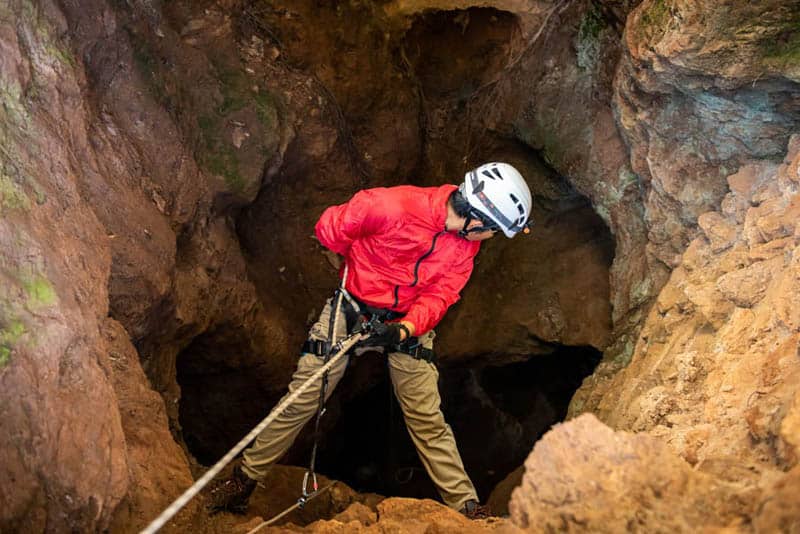 descending into a cave on static rope