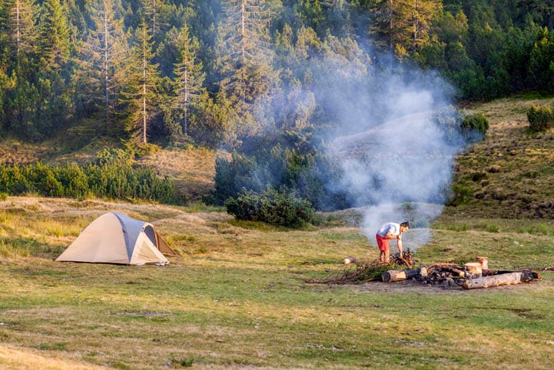 bushcraft camping with tent and fire