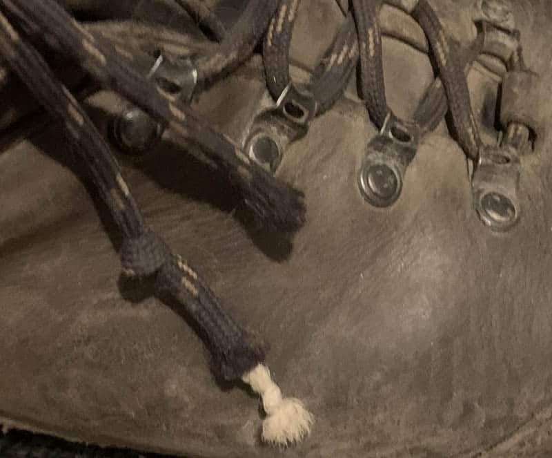 frayed paracord shoelace on hiking boots