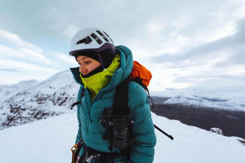 mountaineer woman with multiple layers under winter coat