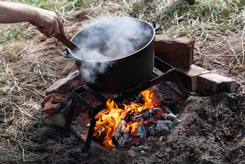 pot of boiling water on bushcraft grill grate